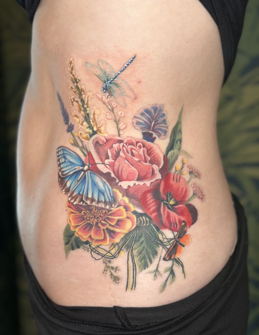 Floral bouquet tattoo with a butterfly and dragonfly
