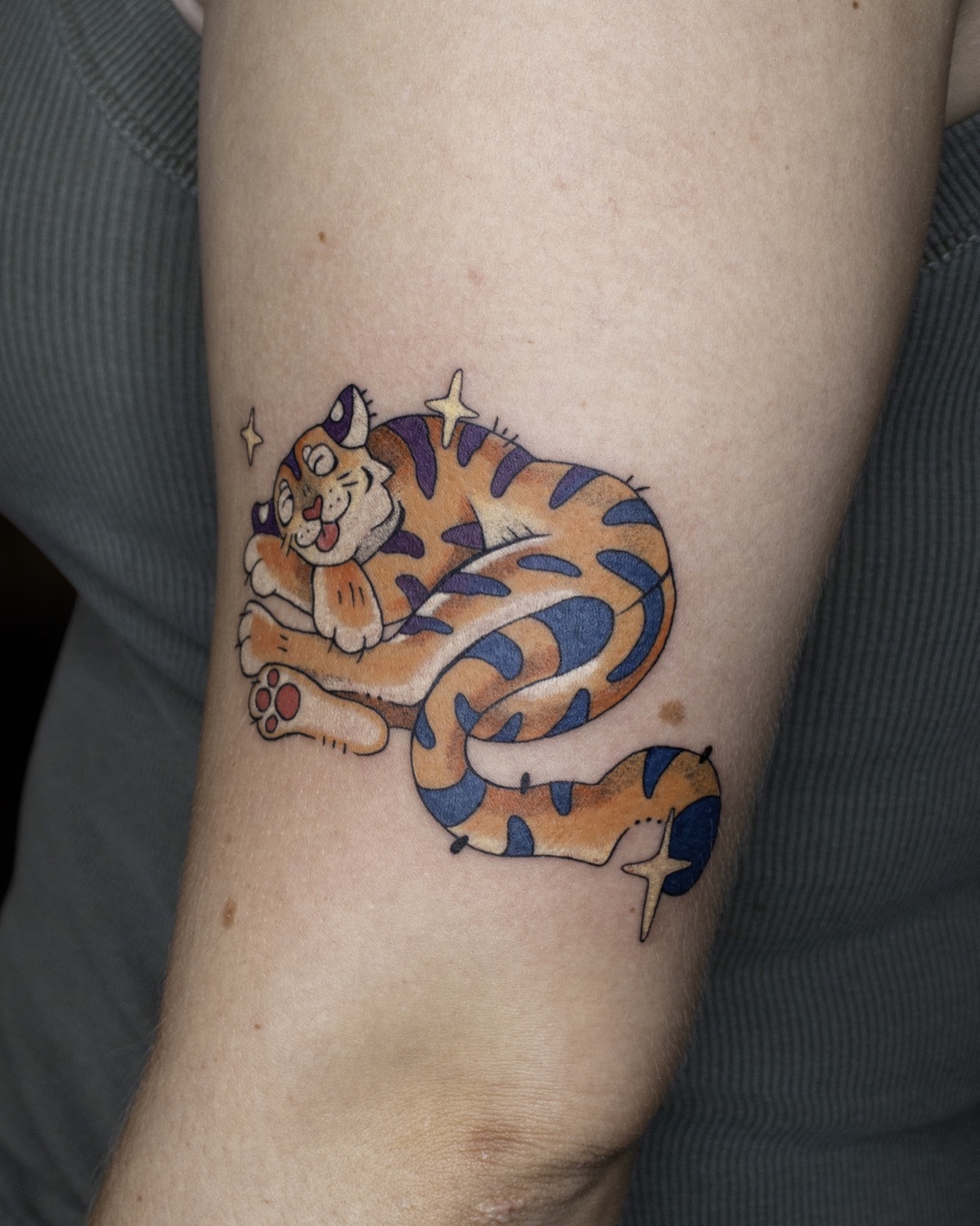 Curled Tiger tattoo
