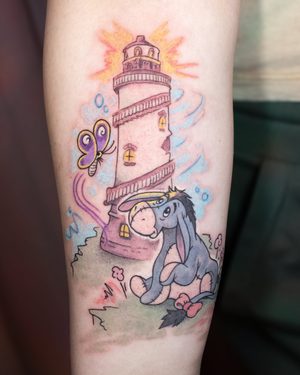 Lighthouse and Eeyore memorial tattoo