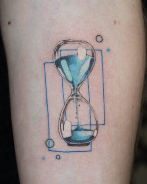 Blue hourglass tattoo on forearm